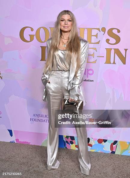 The songwriter Fergie wore a GENNY full look and handbag while attending The Goldie Hawn Foundation Celebrates 20th Anniversary Of MindUP Gala, held at Ron Burkle’s Green Acres in Beverly Hills.